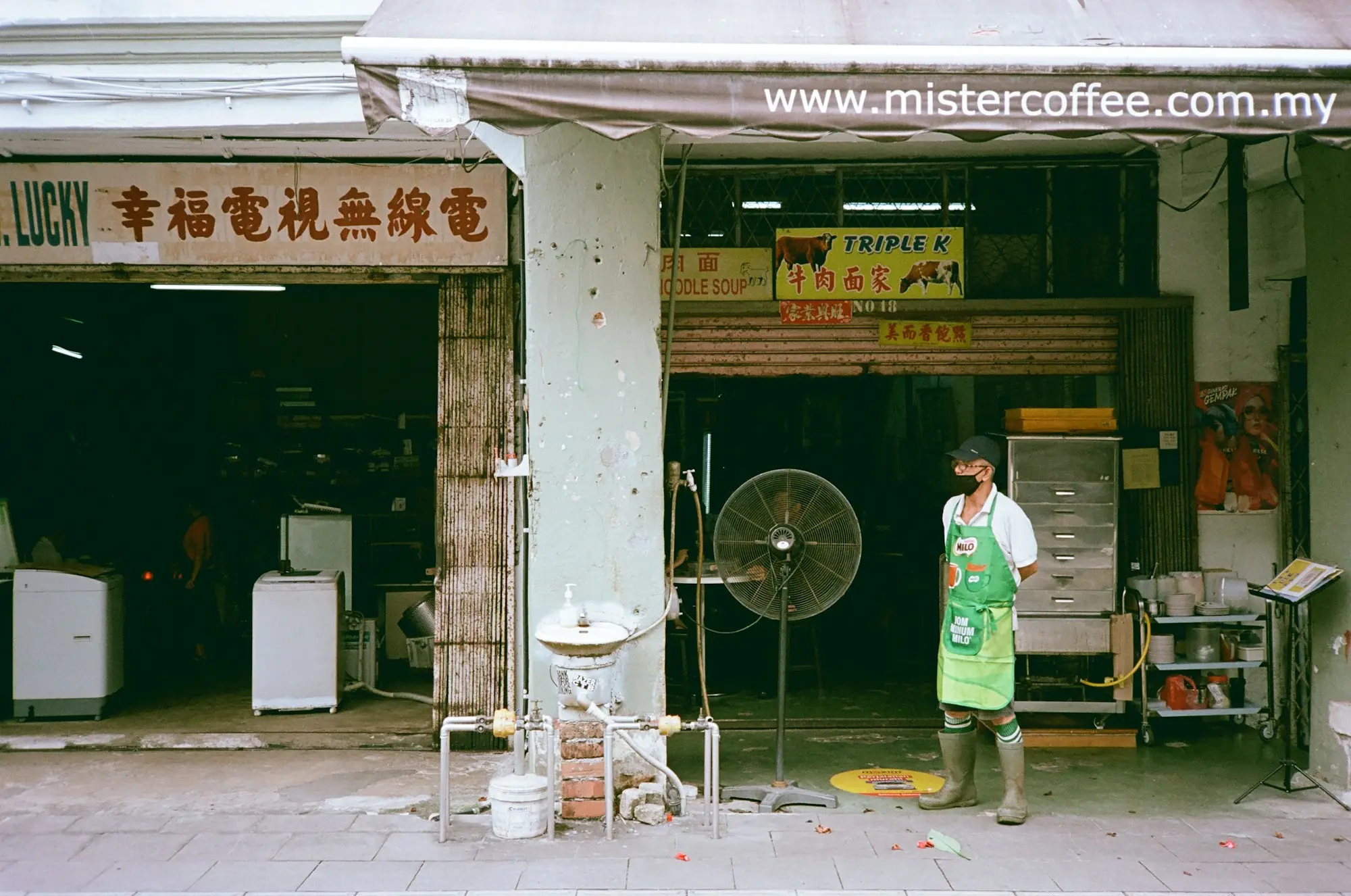 Shop owner standing outside an appliance store