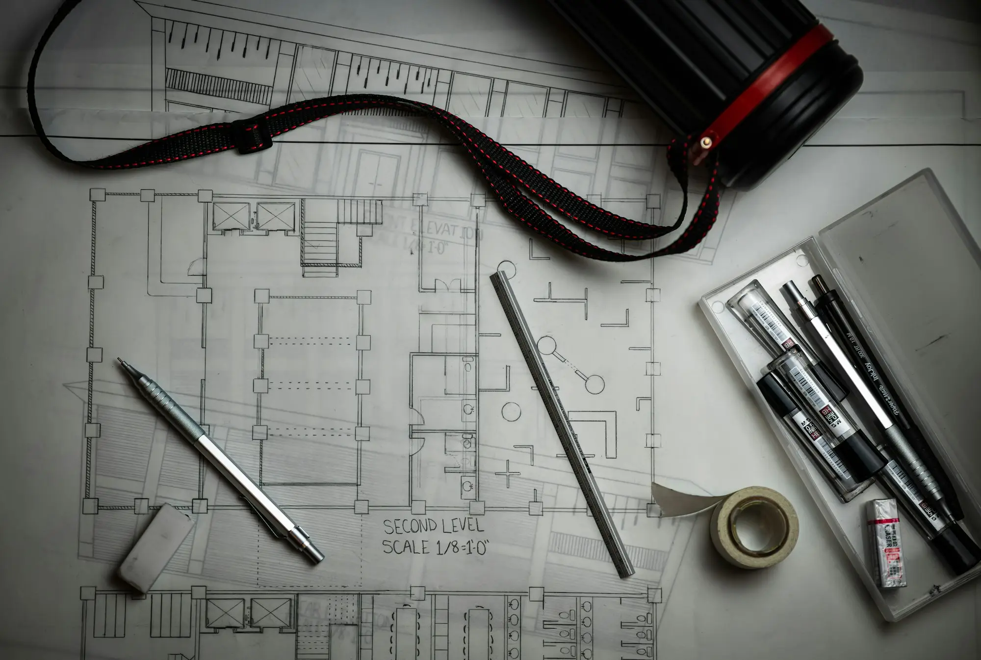 Blueprints with drafting pencils and a metal ruler