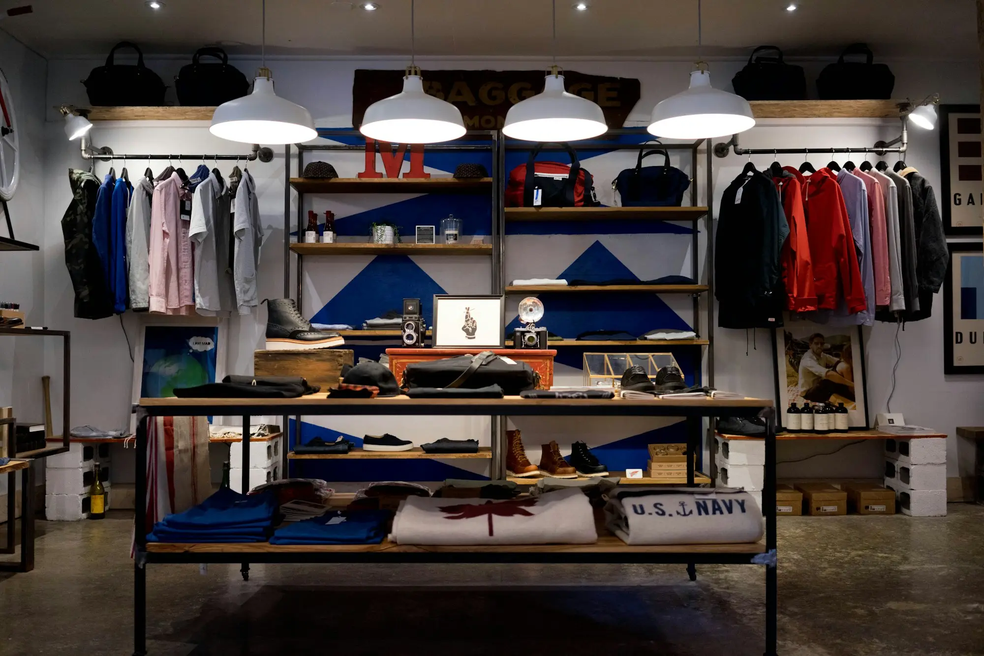 Inside a small clothing store with racks and shelves