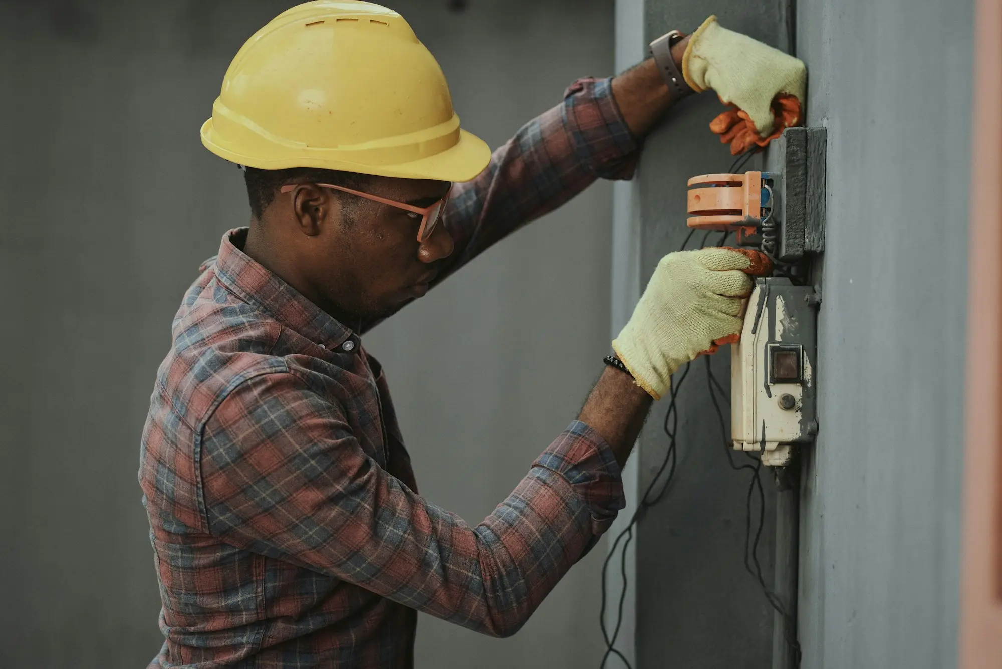 Tradesperson in a yellow hard hat on site