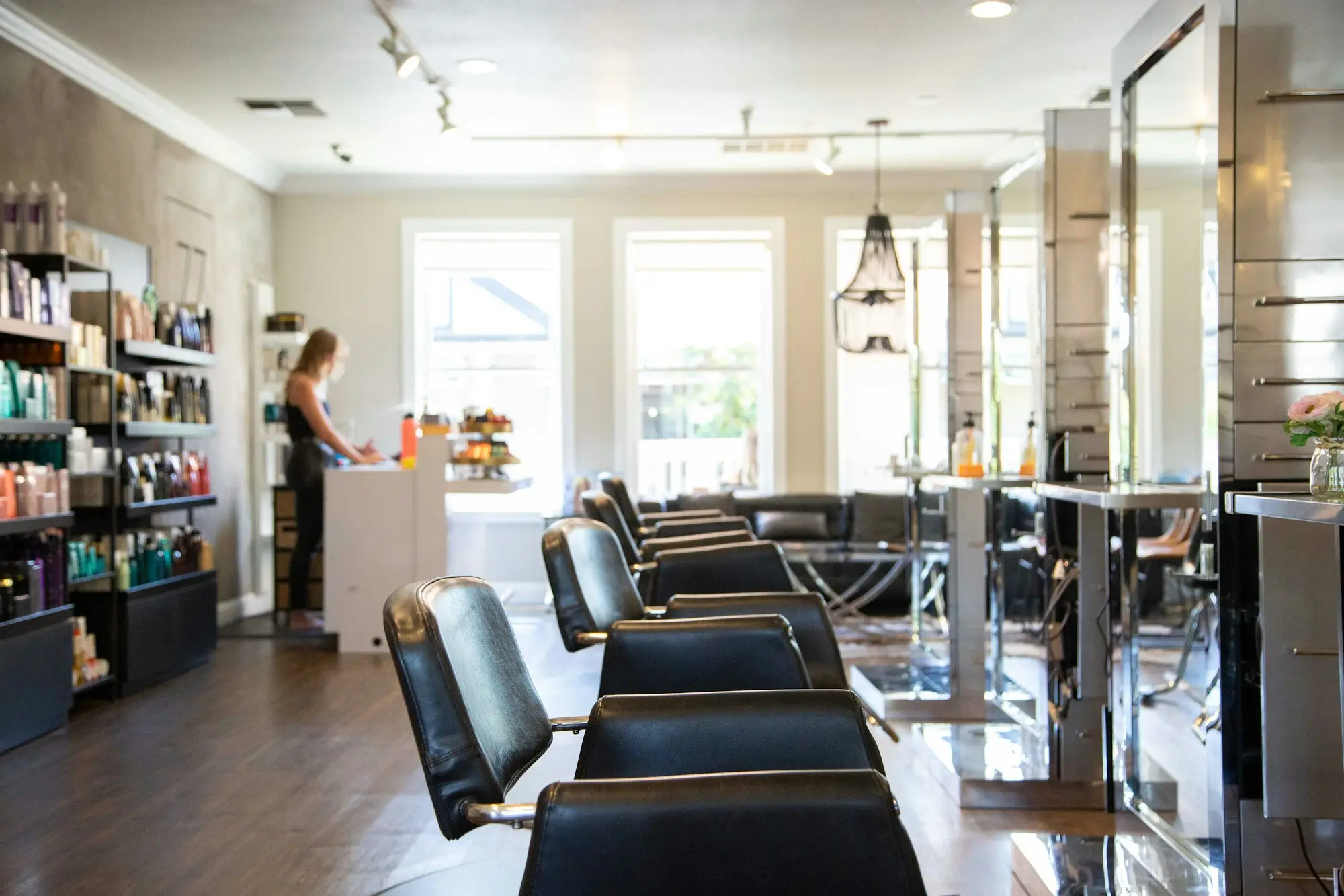 Salon owner standing near the styling chairs