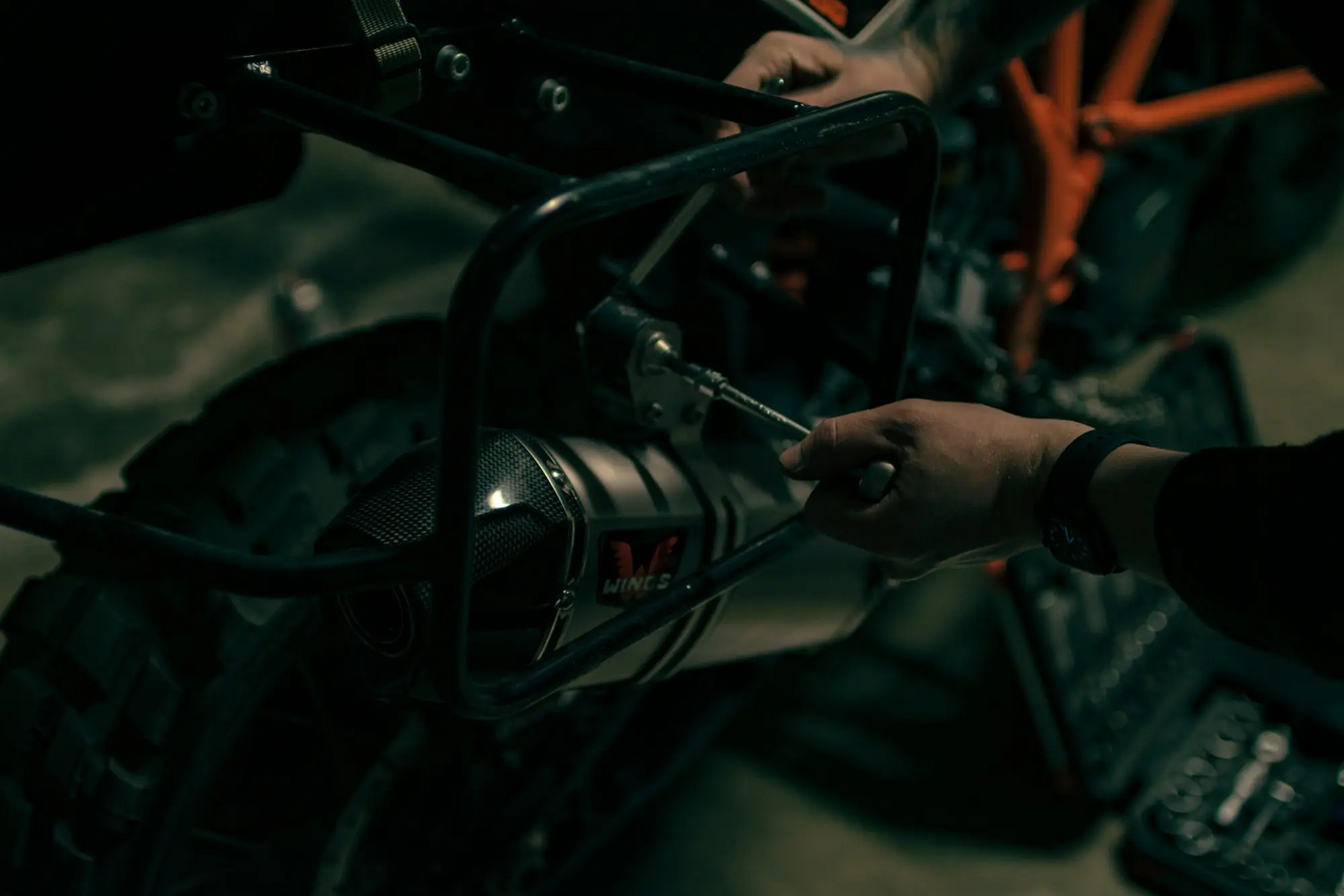 Close-up of a mechanic repairing a motorbike