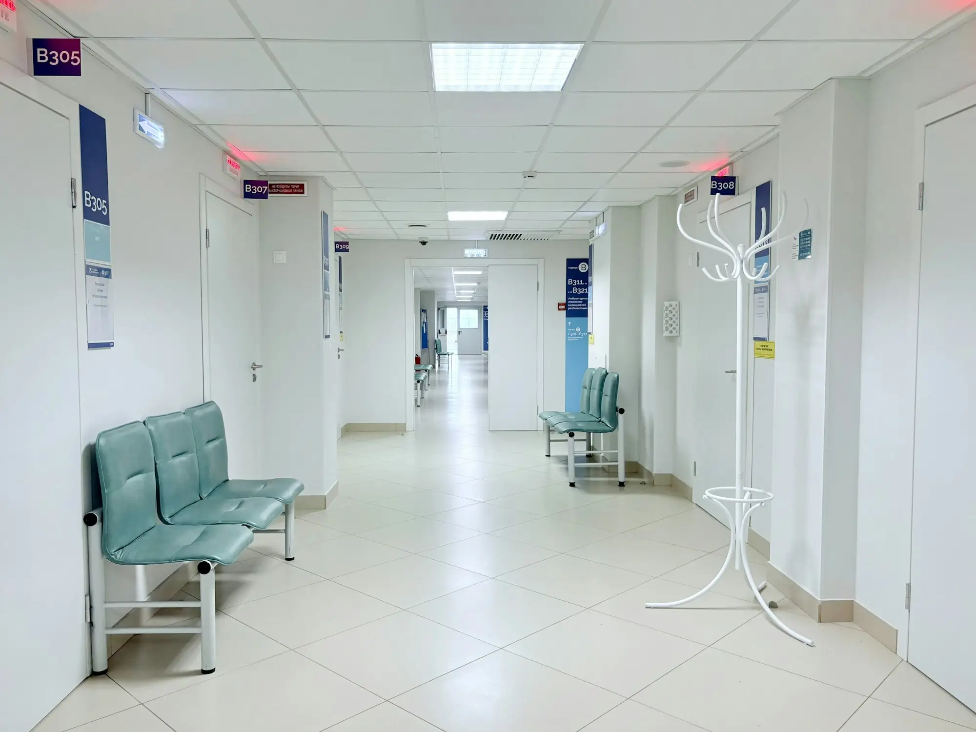 Clinic corridor with benches and consulting room doors