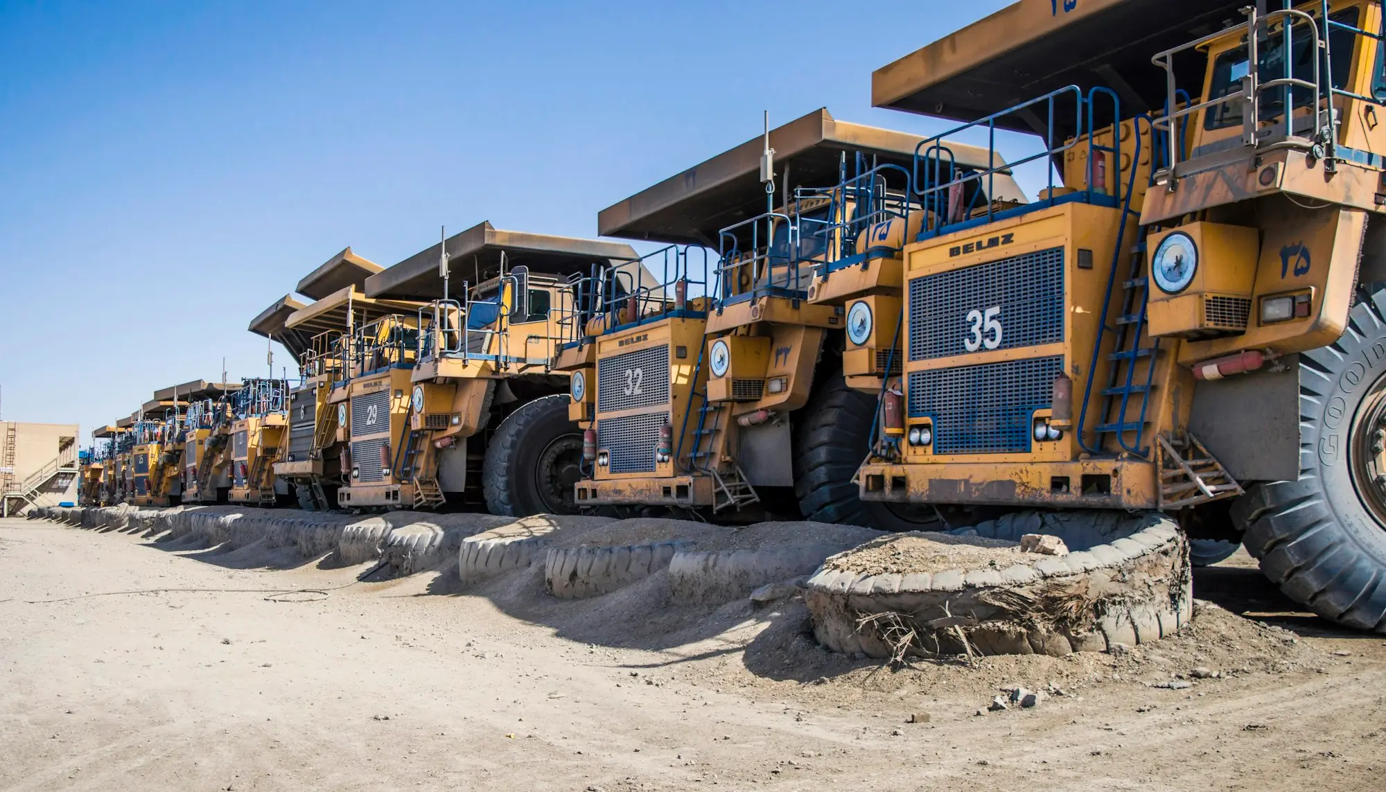 Row of large yellow mining trucks
