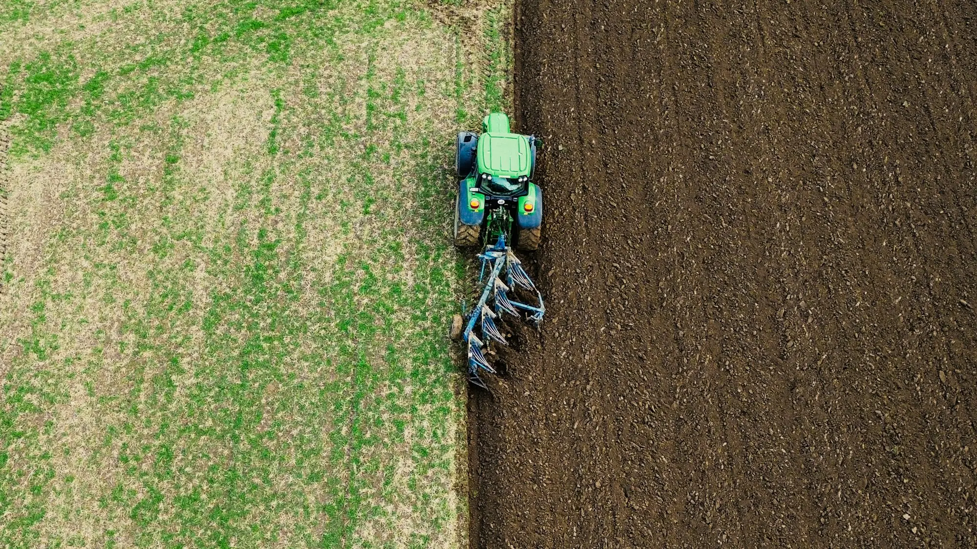 Tractor working a grassy paddock
