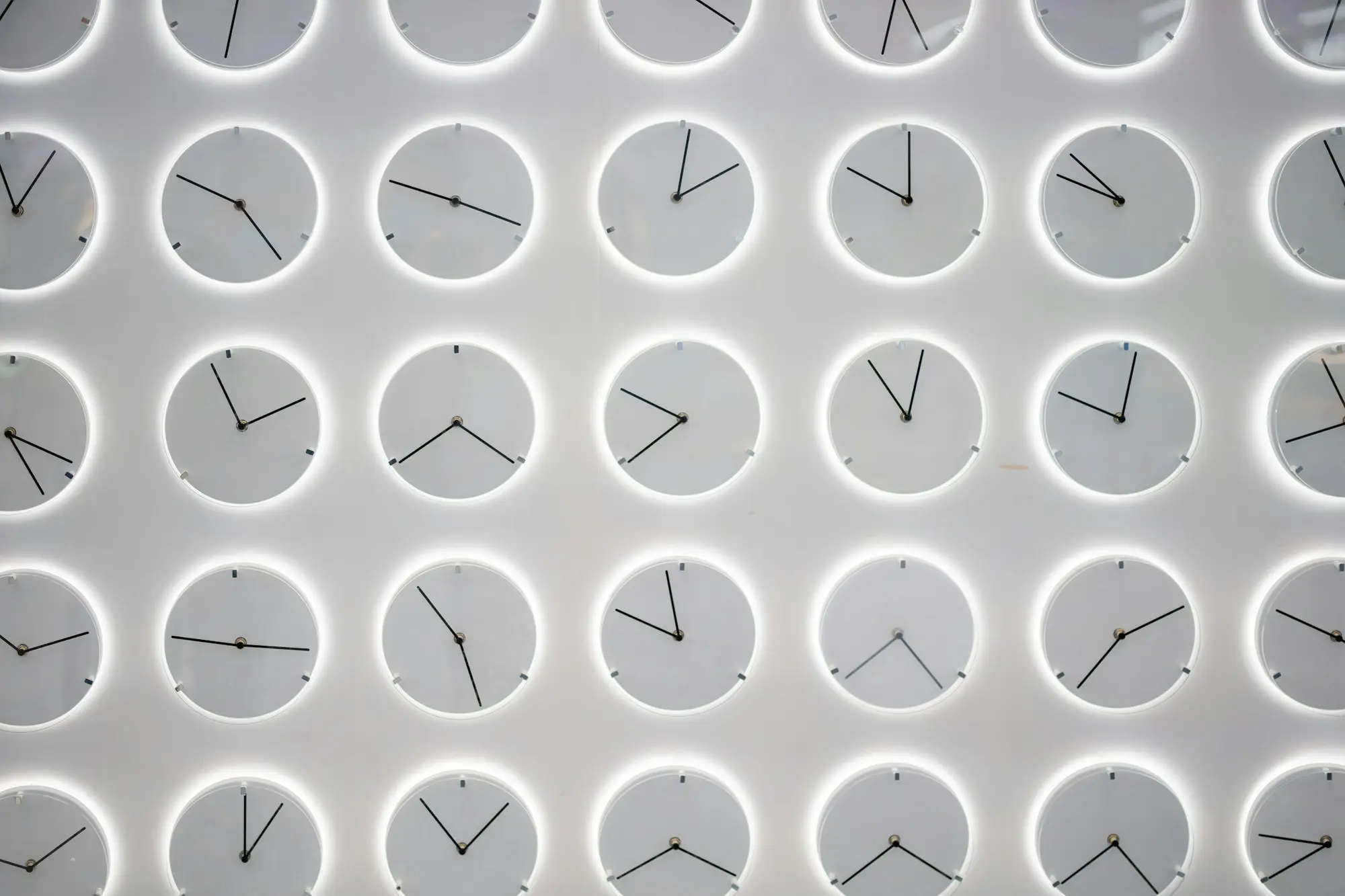 A wall covered in clocks, a reminder of a looming deadline